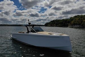 Pardo Yachts P43 2024 Pardo Yachts P43 cruising on a scenic lake under a cloudy sky.