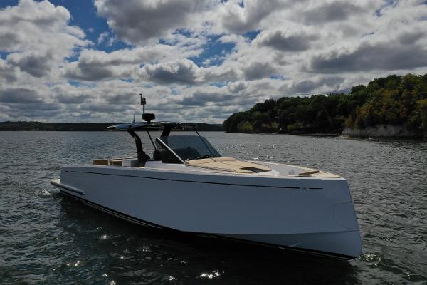 Pardo Yachts P43 2024 Pardo Yachts P43 cruising on a scenic lake under a cloudy sky.