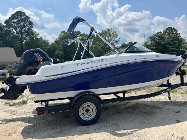 Tahoe 185 S 2024 Tahoe 185 S boat on trailer, blue and white, parked outdoors.