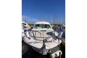 Jeanneau Prestige 30 S 2007 Jeanneau Prestige 30 S. yacht docked at marina under clear blue sky.