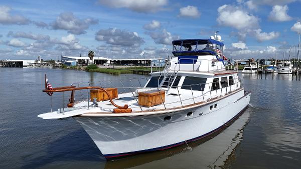 Bertram 58 Custom Convertible complete rebuild in 2010 1980 Bertram 58 Convertible Custom yacht on calm water under a blue sky.