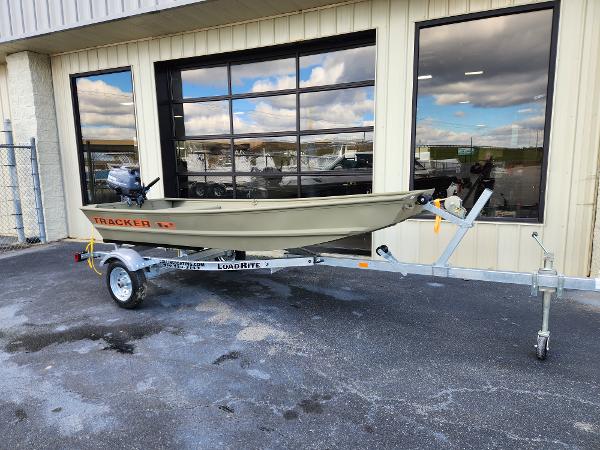 Tracker Grizzly 1236 Utility 2025 Tracker Grizzly 1236 Utility boat on trailer outside showroom.
