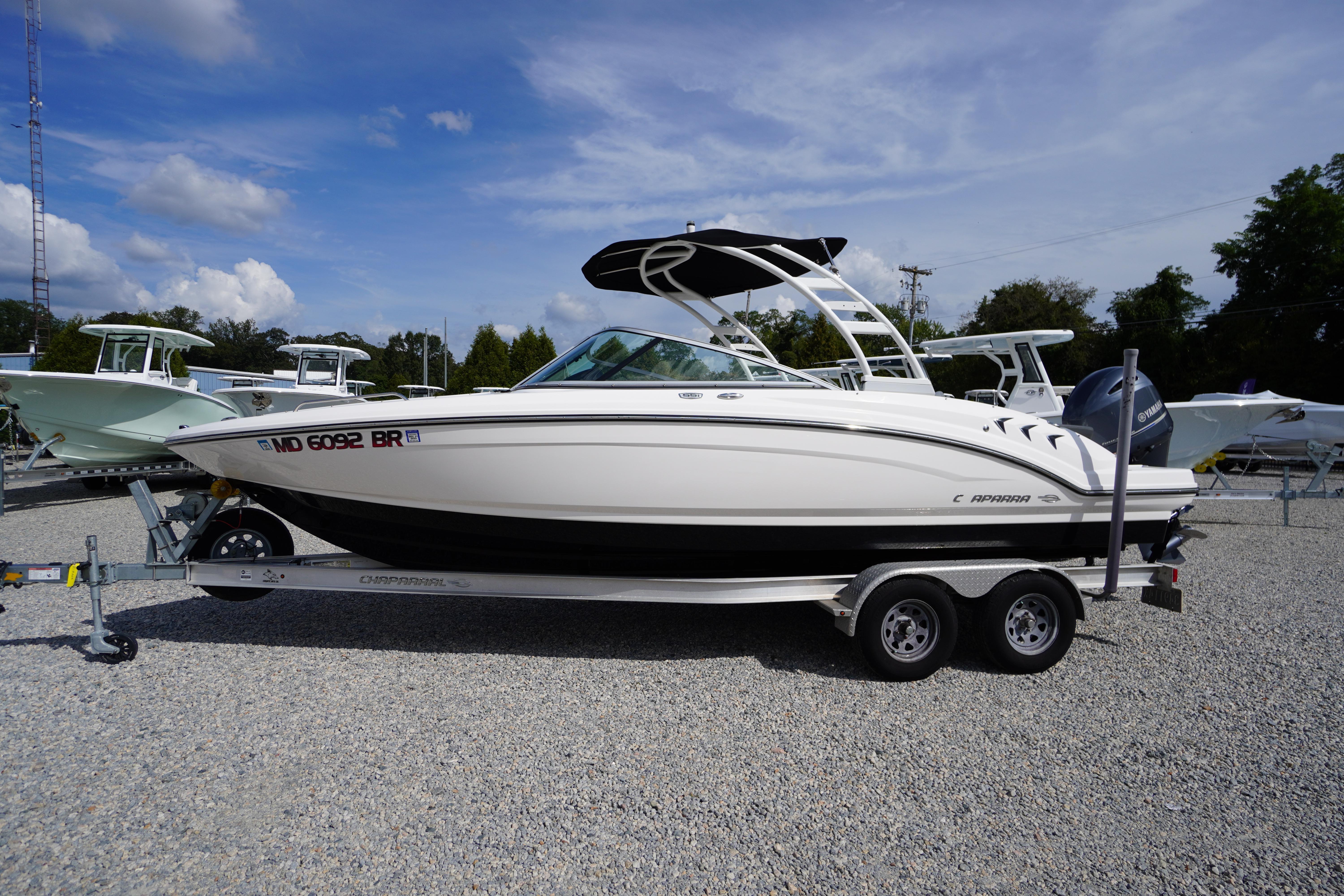 Chaparral 23 SSi OB 2022 Chaparral 23 SSi OB boat on trailer, parked outdoors under blue sky.