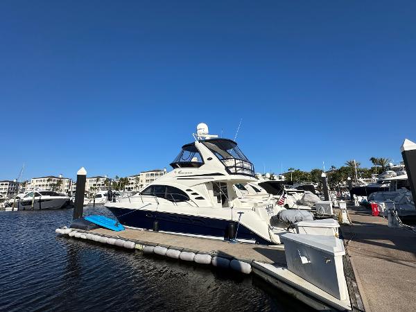 Sea Ray 420 Sedan Bridge 2005 Sea Ray 420 Sedan Bridge yacht docked at marina under clear blue sky.