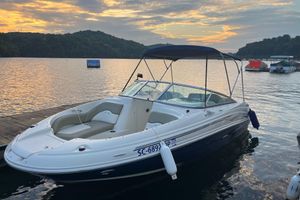 Sea Ray 200 Sundeck 2006 Sea Ray 200 Sundeck boat docked at sunset on a serene lake.