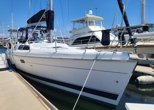 Hunter 450 Passage Sailboat docked at marina, 1998 Hunter 450 Passage, clear blue sky.