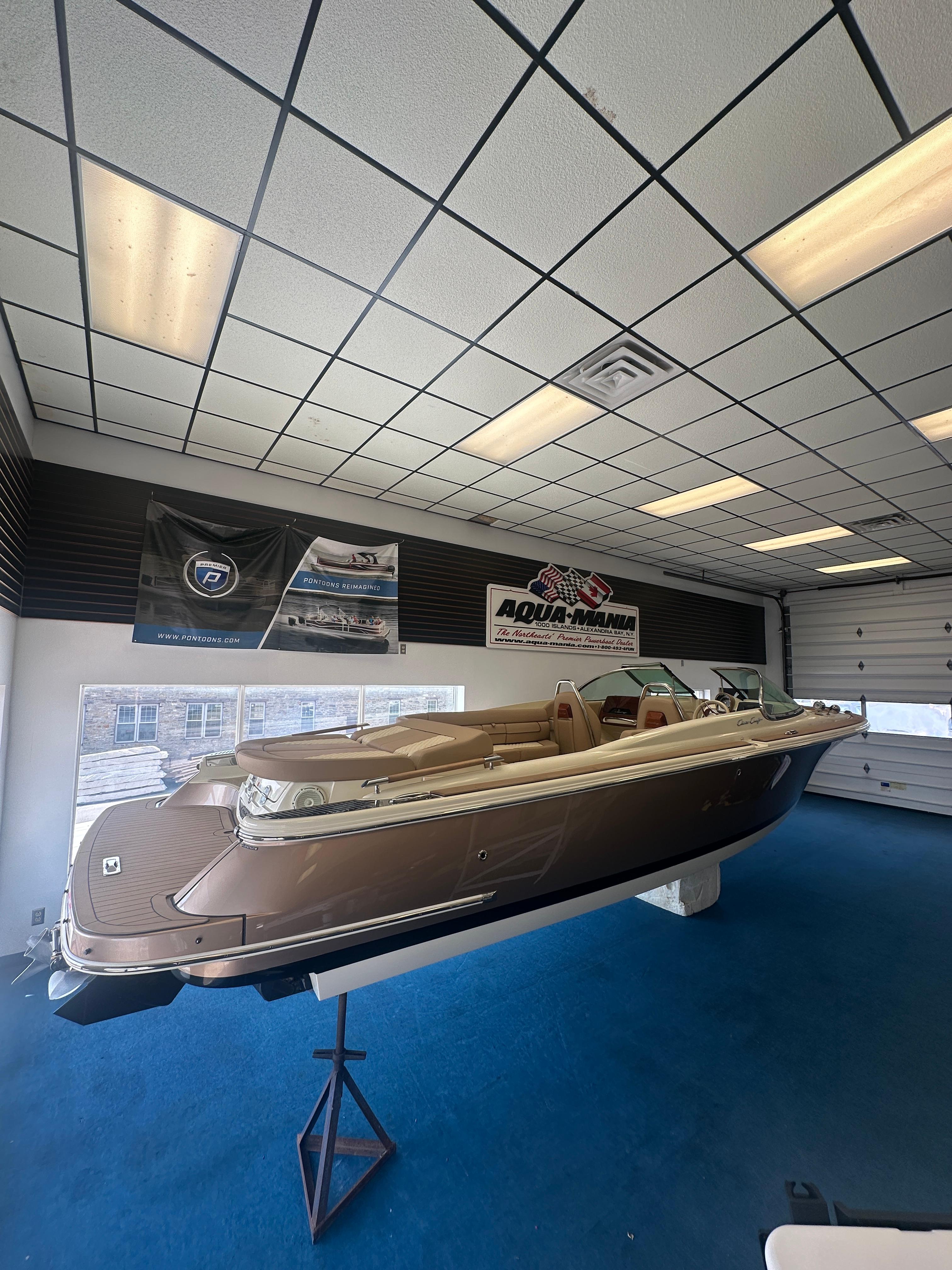 Chris-Craft Launch 25 GT 2024 Chris-Craft Launch 25 GT boat displayed indoors on a stand.