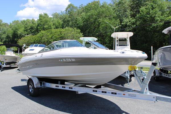 Sea Ray 200 Sport 2005 Sea Ray 200 Sport boat on trailer, parked outdoors with trees in background.