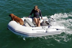 Highfield Roll-Up 200 KAL Woman and dog on 2025 Highfield Roll-Up 200 KAL inflatable boat in open water.