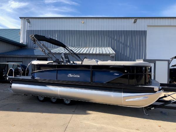Barletta Cabrio 20Q 2024 Barletta Cabrio 20Q pontoon boat parked outside a warehouse.