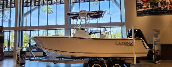 Mako 214 CC 2025 Mako 214 CC boat displayed indoors on a trailer.