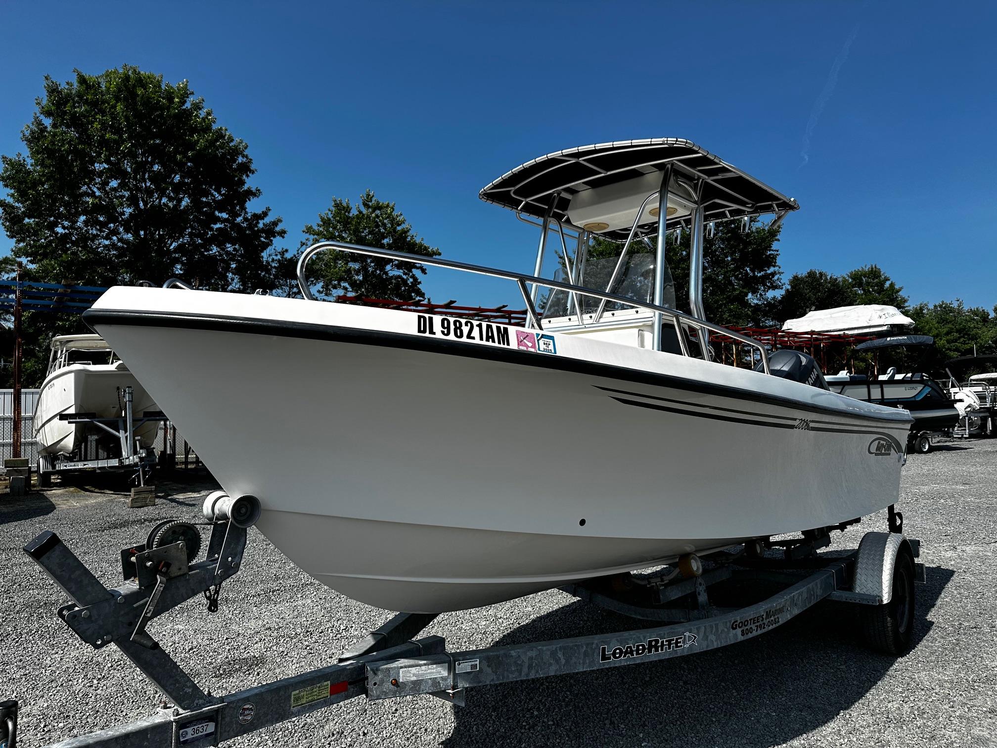 May-Craft 2000CC 2011 May-Craft 2000CC boat on trailer, parked outdoors under clear blue sky.