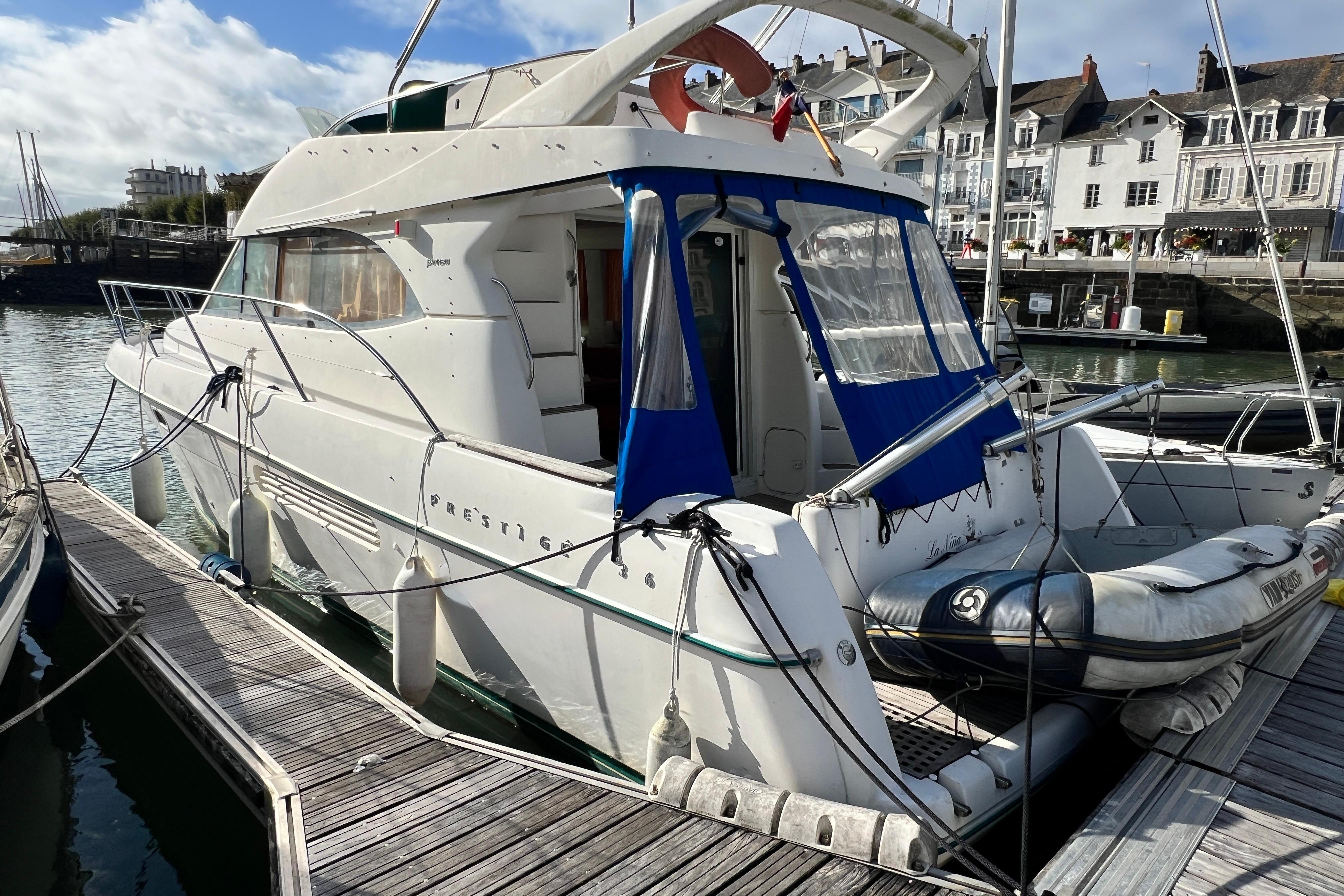 Jeanneau Prestige 36 Jeanneau Prestige 36 yacht docked at marina, showcasing elegant design and spacious deck.