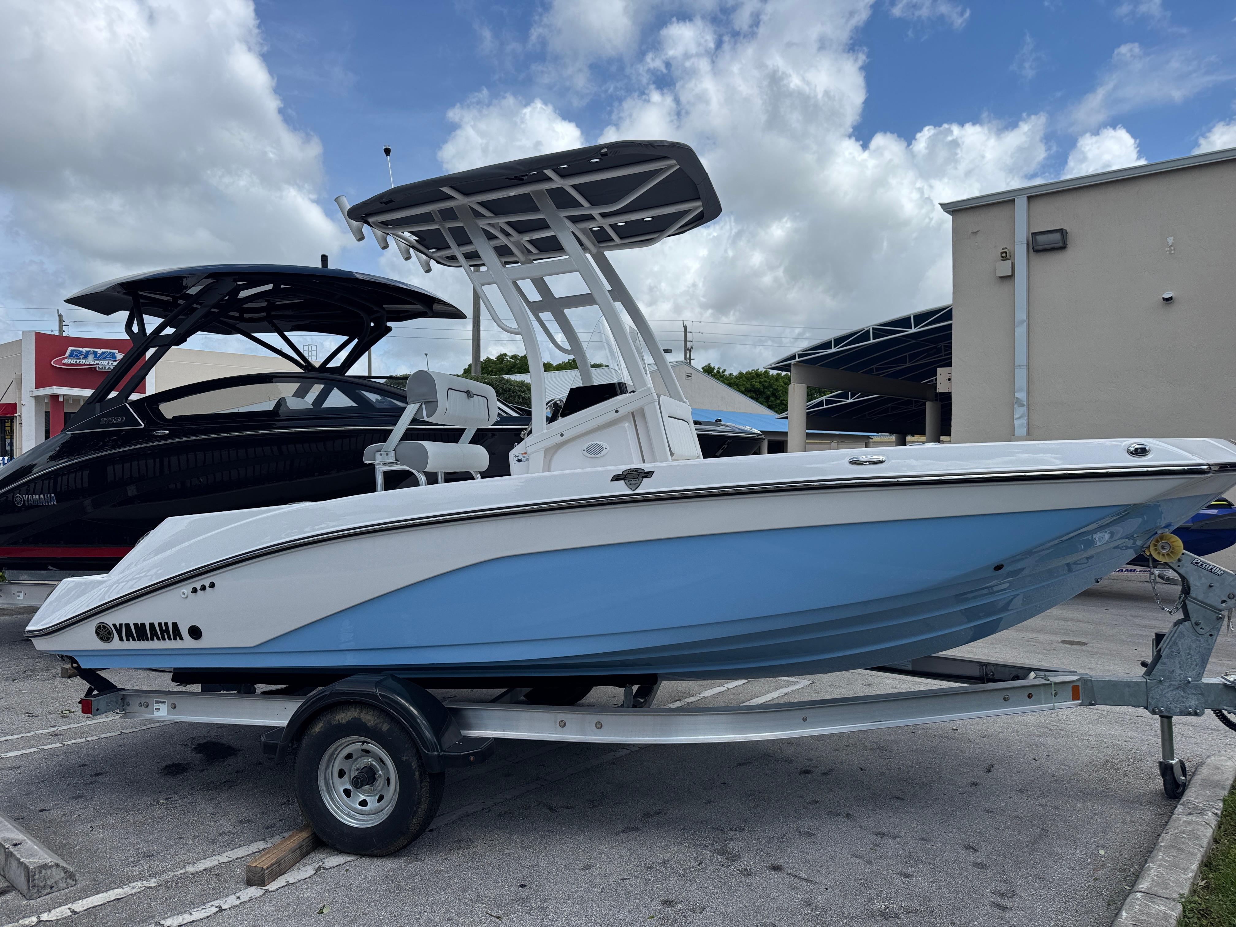 Yamaha Boats 195 FSH Sport 2025 Yamaha Boats 195 FSH Sport in blue and white on a trailer.