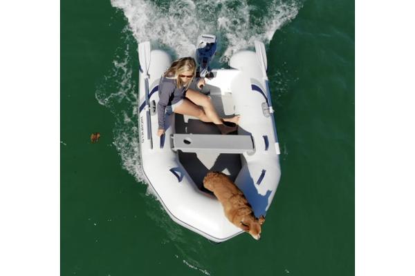 Highfield Roll-Up 280 KAM 2025 Highfield Roll-Up 280 KAM inflatable boat with woman and dog on water.