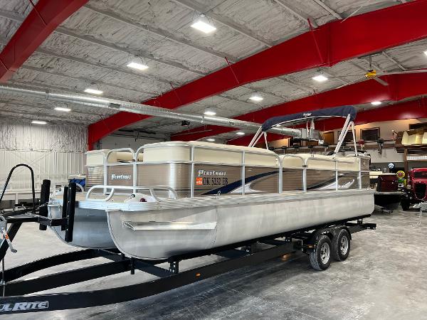 PlayCraft 2400 Clipper 2013 PlayCraft 2400 Clipper pontoon boat on trailer in indoor storage facility.