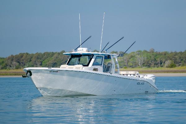 Solace 41 CS 2022 Solace 41 CS boat cruising on calm water with fishing rods.