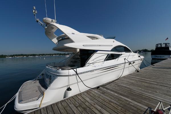 Fairline Phantom 46 2007 Fairline Phantom 46 yacht docked at a marina under clear blue skies.