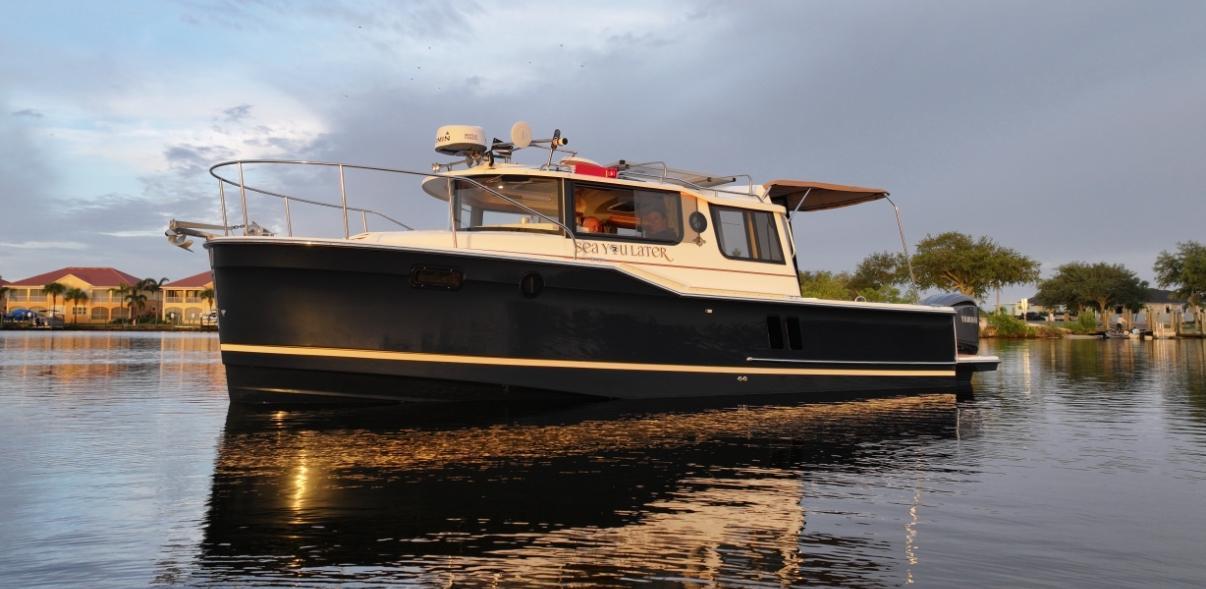 Ranger Tugs R-27 2022 Ranger Tugs R-27 boat on calm water at sunset.