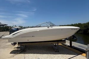 Chaparral 230 Suncoast 2016 Chaparral 230 Suncoast boat on dock, side view, clear sky background.
