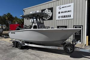 Sea Pro 245FLX Sandbar 2026 Sea Pro 245FLX Sandbar boat on trailer outside dealership with brand logos.