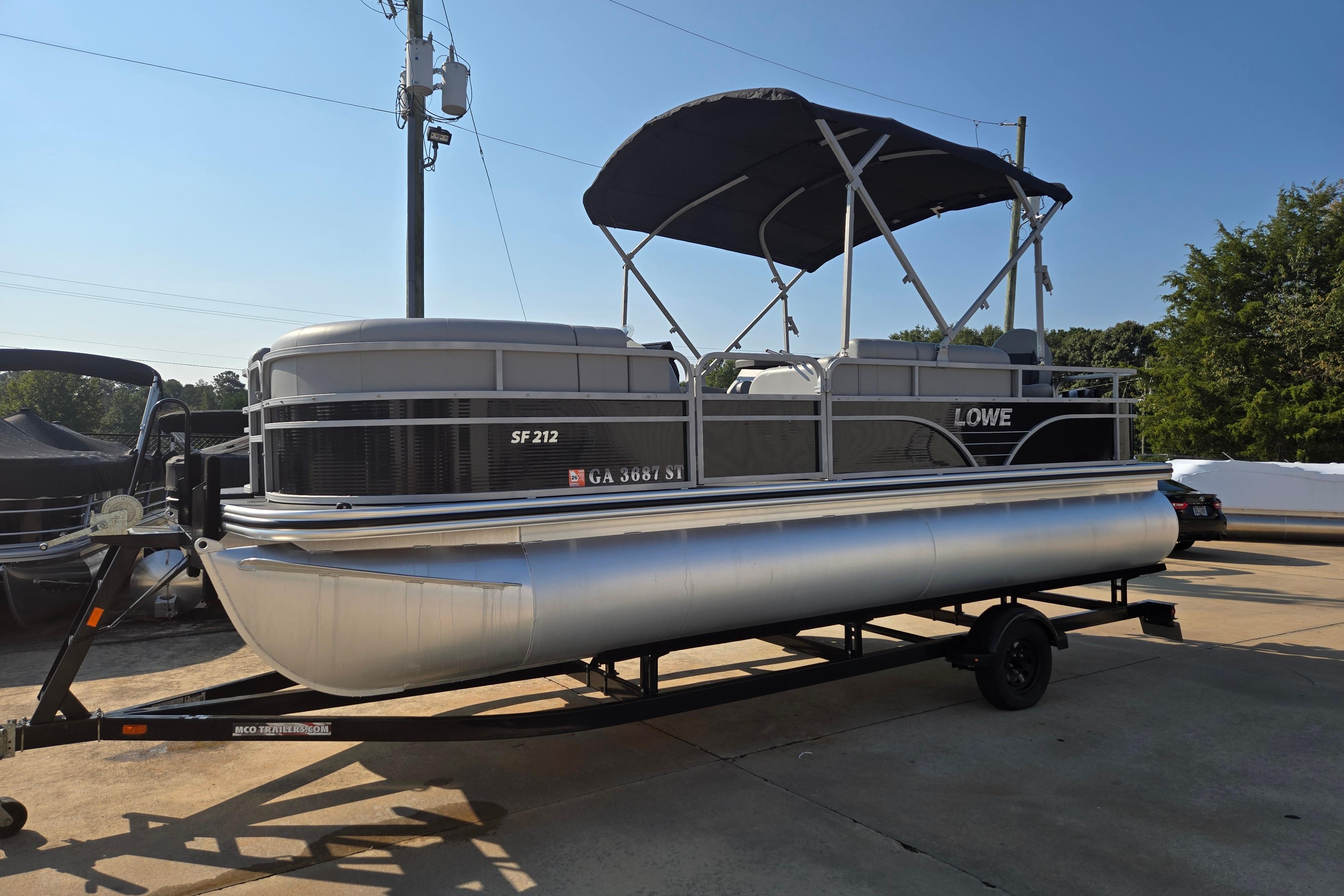 Lowe SF 212 Sport Fish 2021 Lowe SF 212 Sport Fish pontoon boat on trailer, parked outdoors.