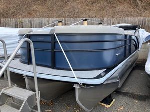 Harris Cruiser 210 2025 Harris Cruiser 210 pontoon boat in storage, blue exterior, docked on land.