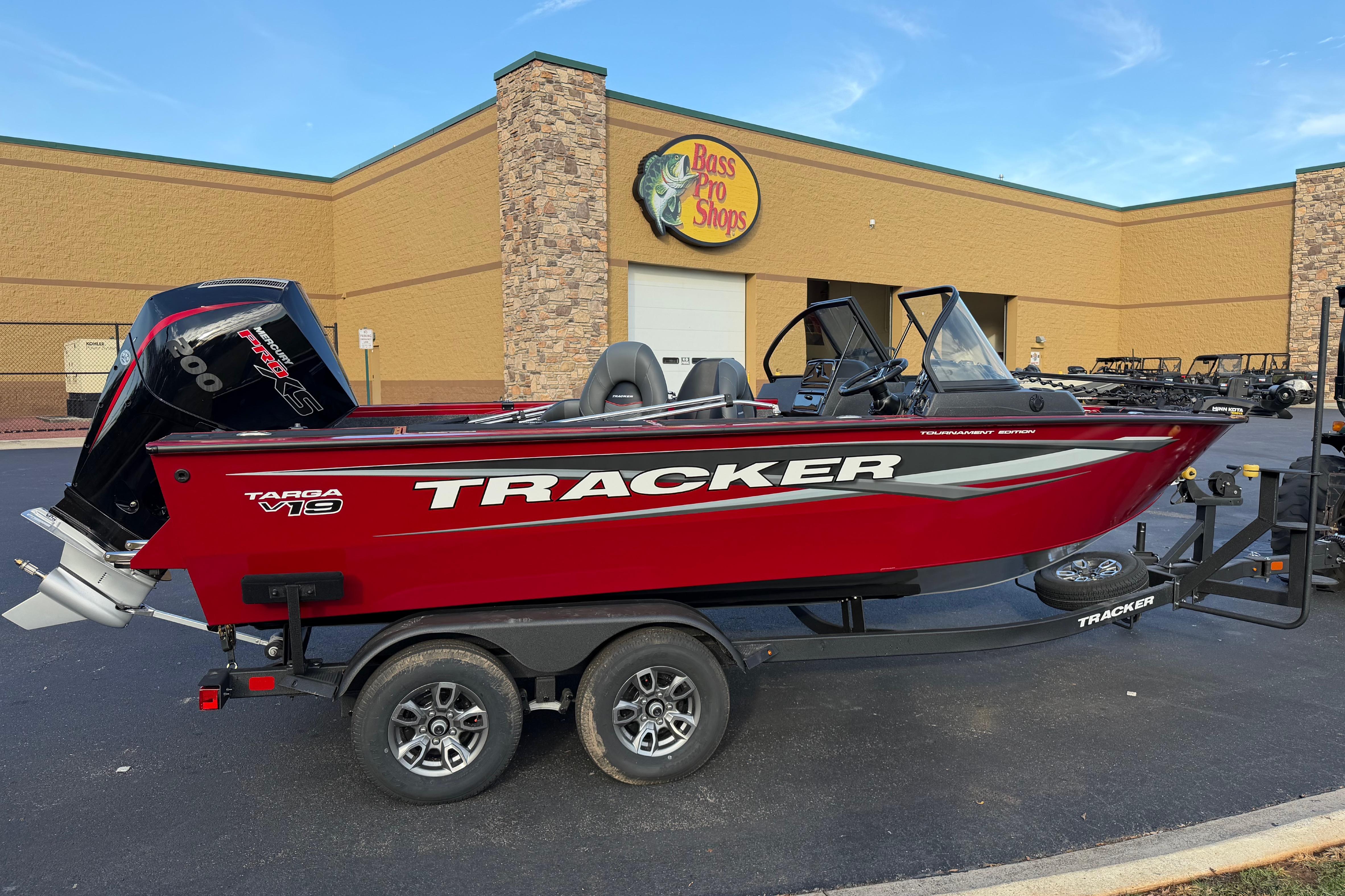 Tracker Targa V-19 Combo 2026 Tracker Targa V-19 Combo boat in red, parked outside Bass Pro Shops.
