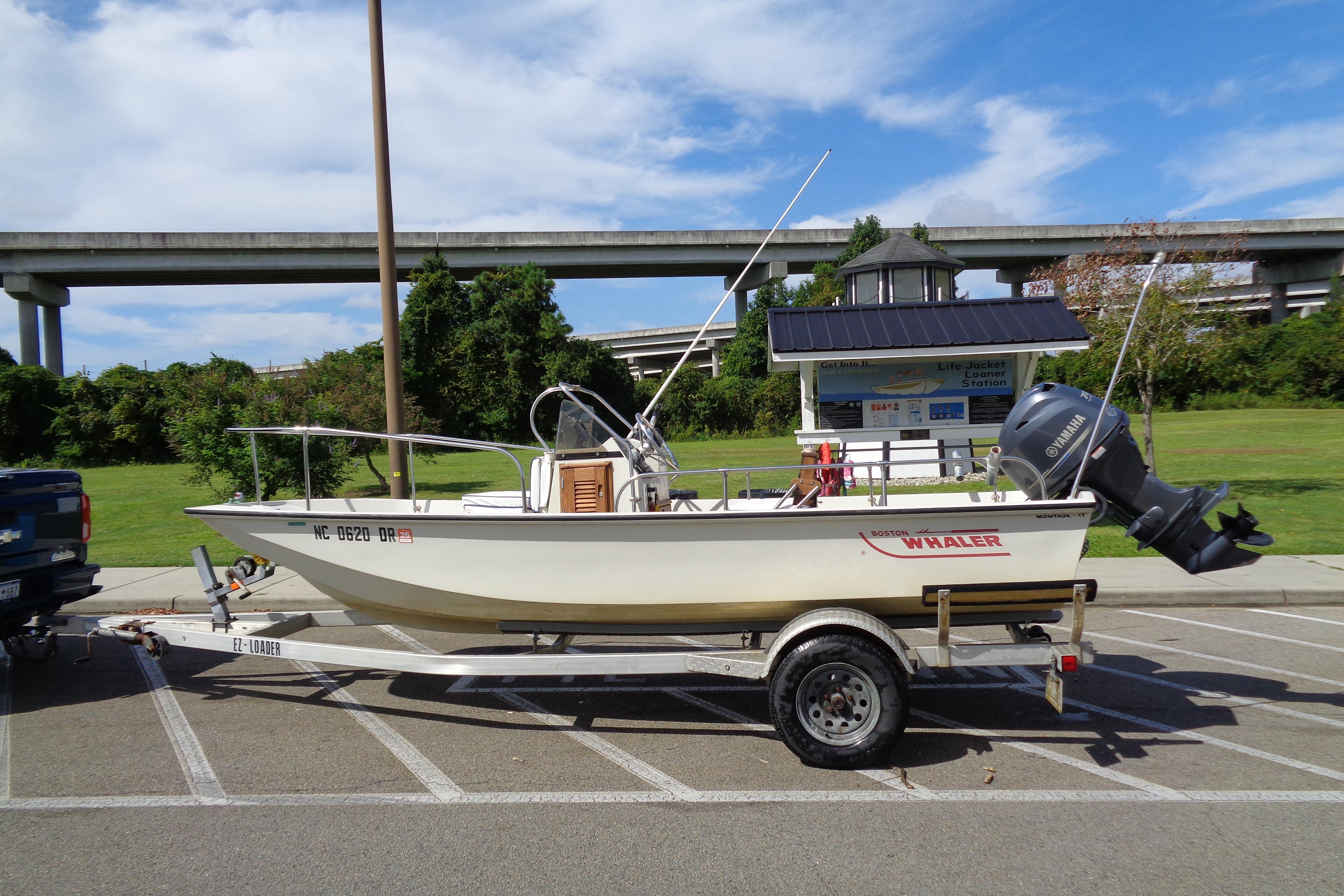 Boston Whaler Montauk 17 CC 1986 Boston Whaler Montauk 17 CC boat on trailer in parking lot.