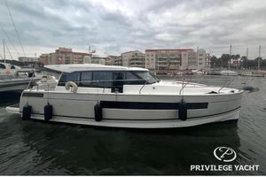Jeanneau NC 14 2018 Jeanneau NC14 yacht docked in marina, overcast sky, Privilege Yacht branding.