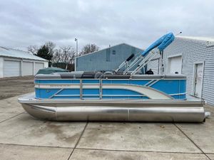 Bennington 20 SL 2025 Bennington 20 SL pontoon boat in blue and silver, parked on concrete.