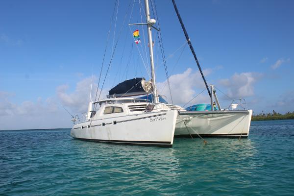 Leopard 47 Leopard 47 catamaran from 2001 anchored in clear blue water.