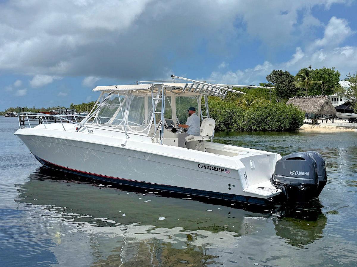 Contender 35 Express Side Console 1994 Contender 35 Express Side Console boat on calm water, featuring Yamaha engines.