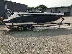 Hurricane SunDeck 235 OB 2022 Hurricane SunDeck 235 OB boat on trailer, parked outdoors.