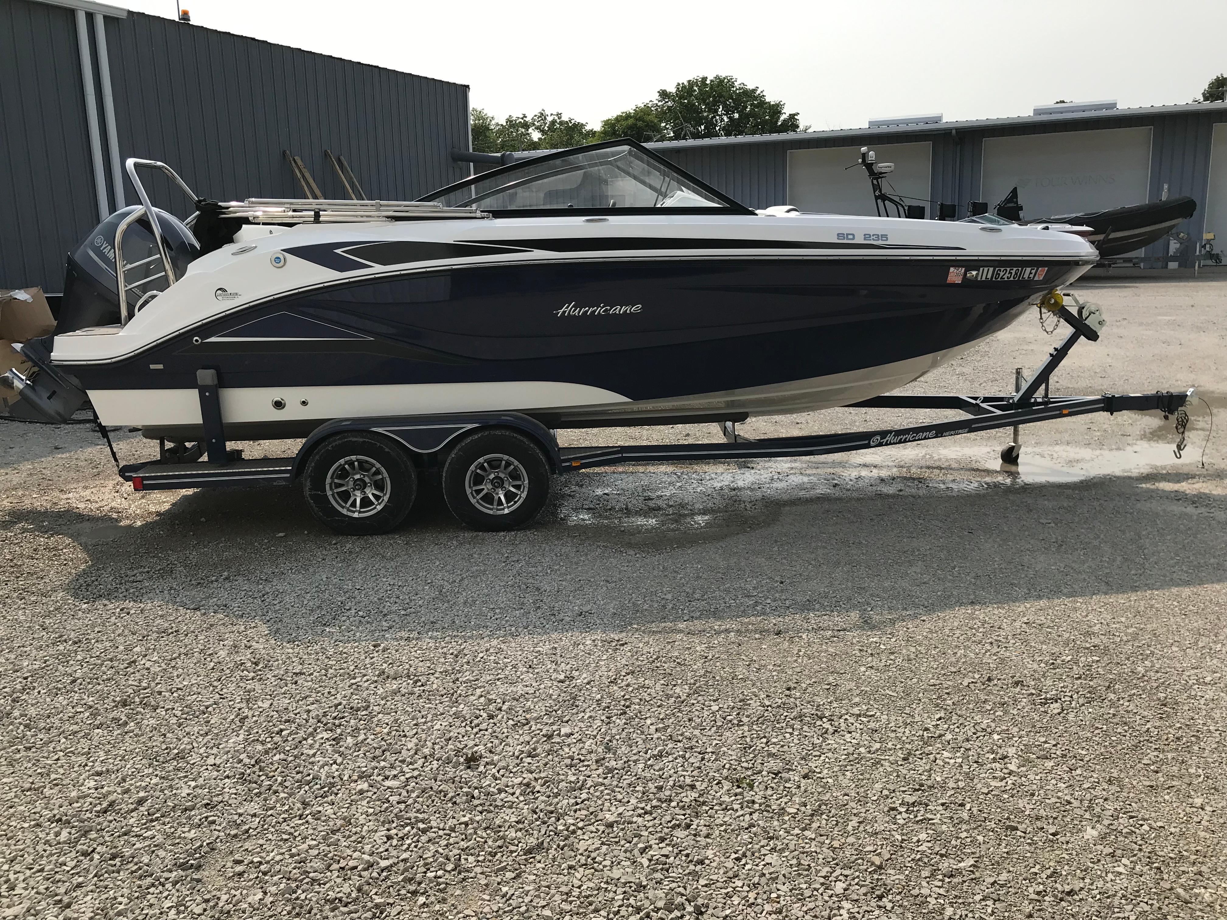 Hurricane SunDeck 235 OB 2022 Hurricane SunDeck 235 OB boat on trailer, parked outdoors.