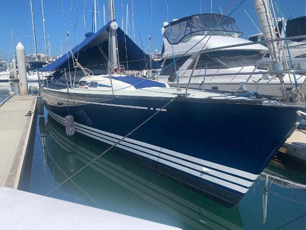 X-Yachts X-482 2003 X-Yachts X-482 sailboat docked in marina, featuring sleek blue hull and white stripes.