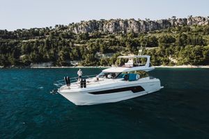 Prestige 590 Luxury 2022 Prestige 590 yacht cruising near scenic coastline.