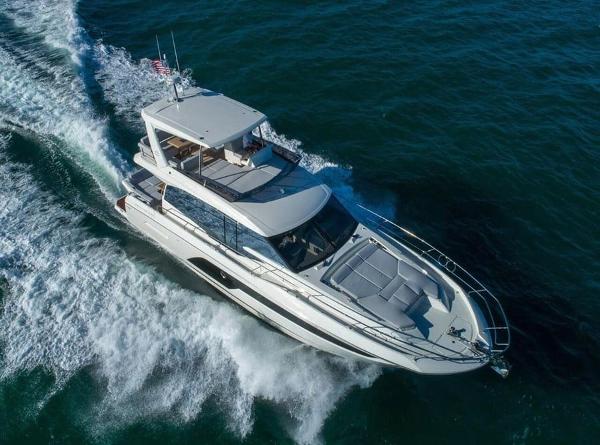 Prestige 590 2022 Prestige 590 yacht cruising on open water, aerial view.