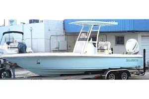 ShearWater 260 SS 2023 ShearWater 260 SS boat on trailer, light blue hull, parked outdoors.