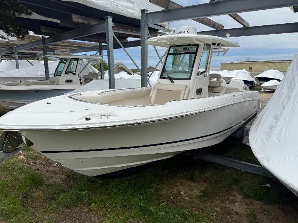 Boston Whaler 280 Outrage 2017 Boston Whaler 280 Outrage boat in storage, white exterior, side view.