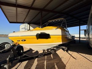 Rinker 232 Captiva Bowrider Yellow 2005 Rinker 232 Captiva Bowrider boat on trailer under shelter.