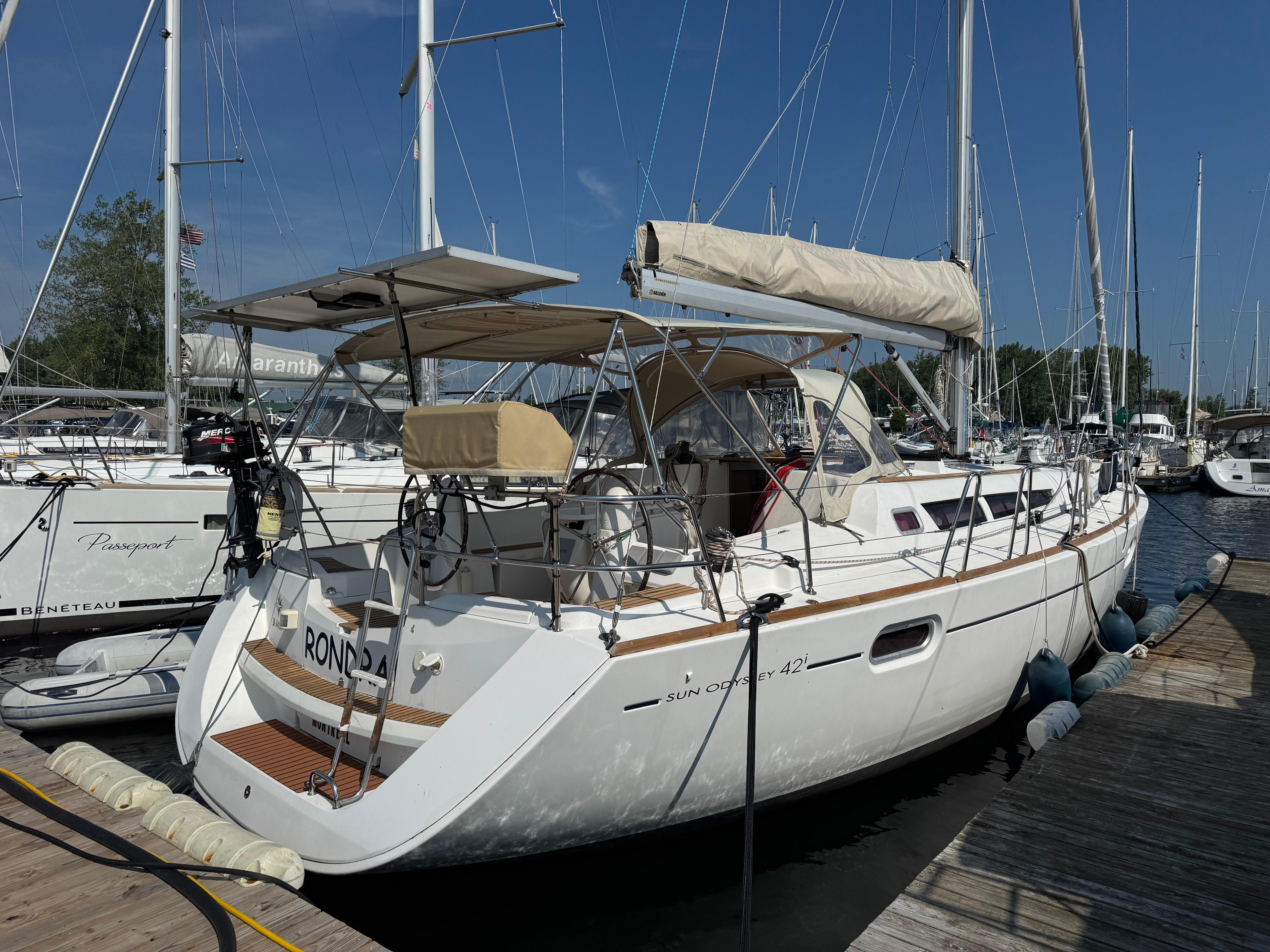 Jeanneau Sun Odyssey 42 I 2008 Jeanneau Sun Odyssey 42 I sailboat docked at a marina under clear blue skies.