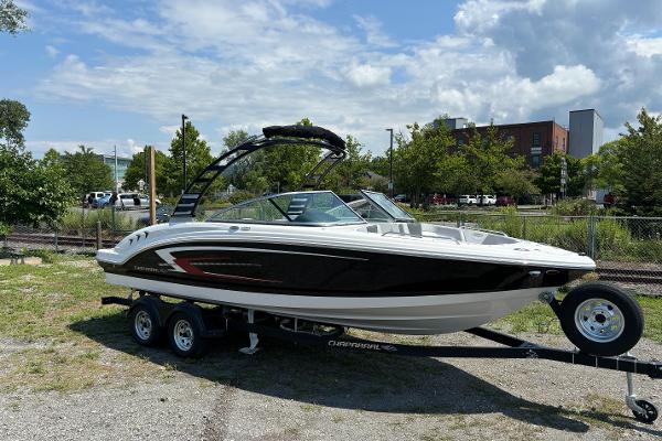 Chaparral 23 SSi 2025 Chaparral 23 SSi boat on a trailer in an outdoor setting.