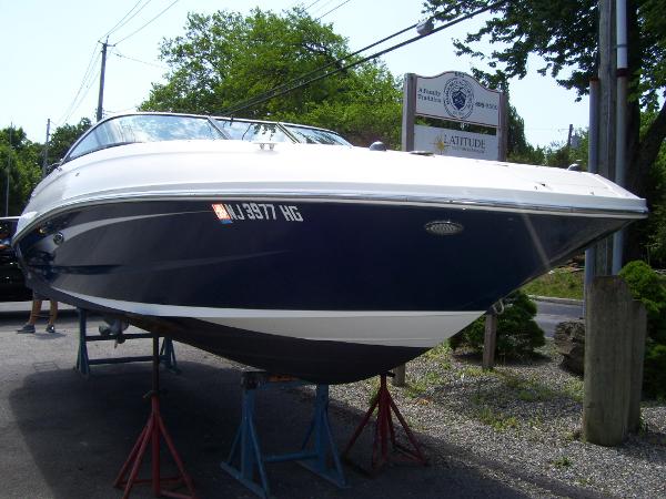 Sea Ray 240 Sundeck 2015 Sea Ray 240 Sundeck boat on stands, parked outdoors.