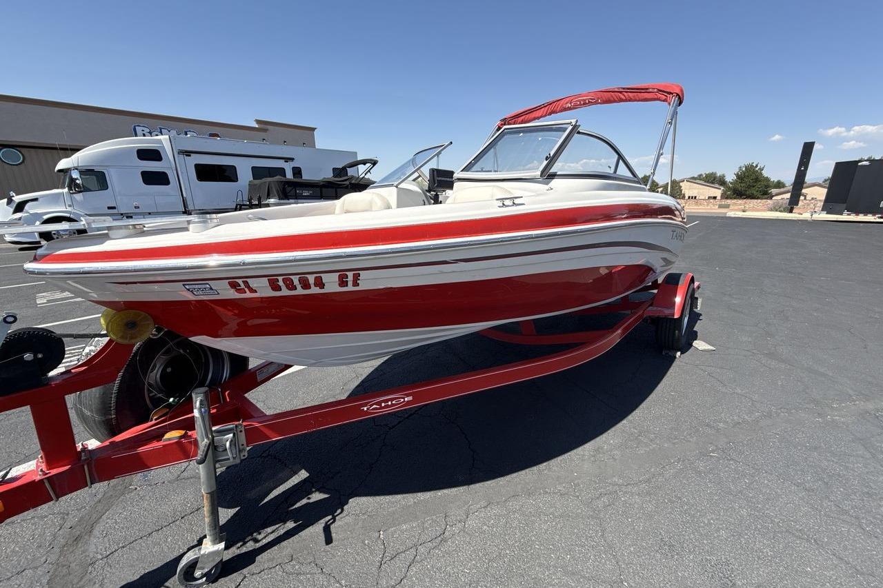 Tahoe Q5i SF 2008 Tahoe Q5i SF boat on trailer, red and white design, parked outdoors.