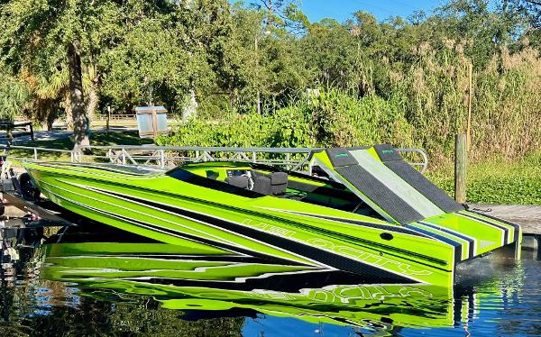 Velocity Raptor Bright green 2025 Velocity Raptor speedboat docked on a sunny day.