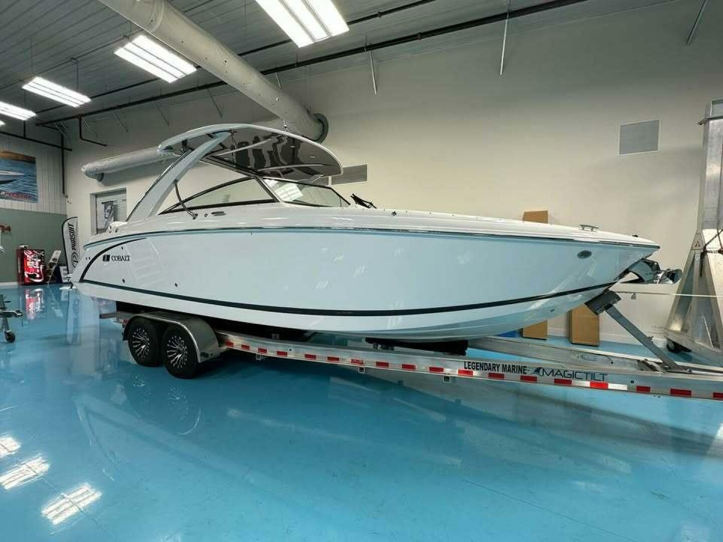 Cobalt 30SC Outboard 2024 Cobalt 30SC Outboard boat on trailer in showroom.