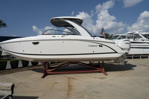 Cobalt 30SC Outboard 2024 Cobalt 30SC Outboard boat on display under a clear blue sky.