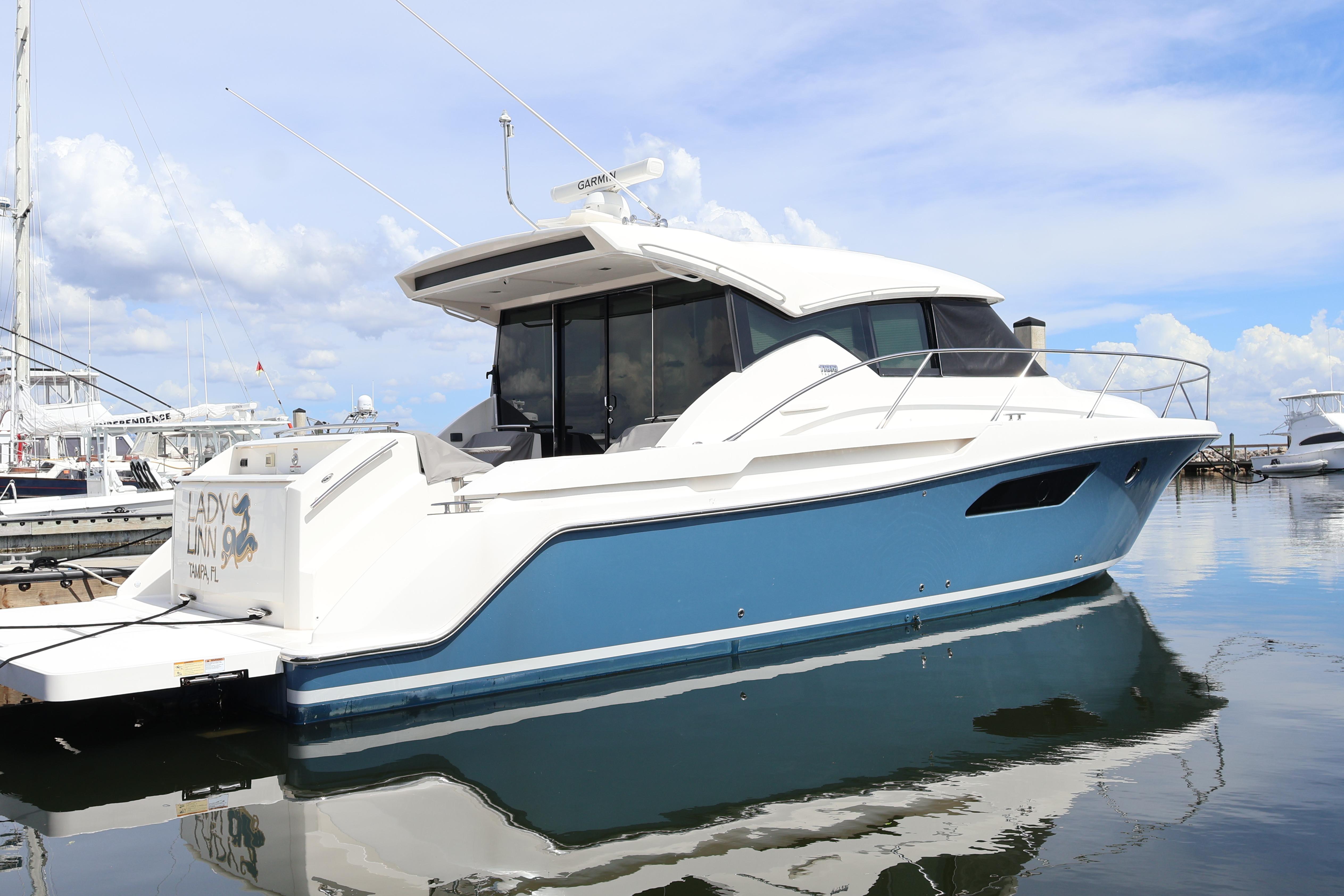 Tiara Yachts C44 Coupe 2020 Tiara Yachts C44 Coupe docked, featuring sleek design and blue hull.