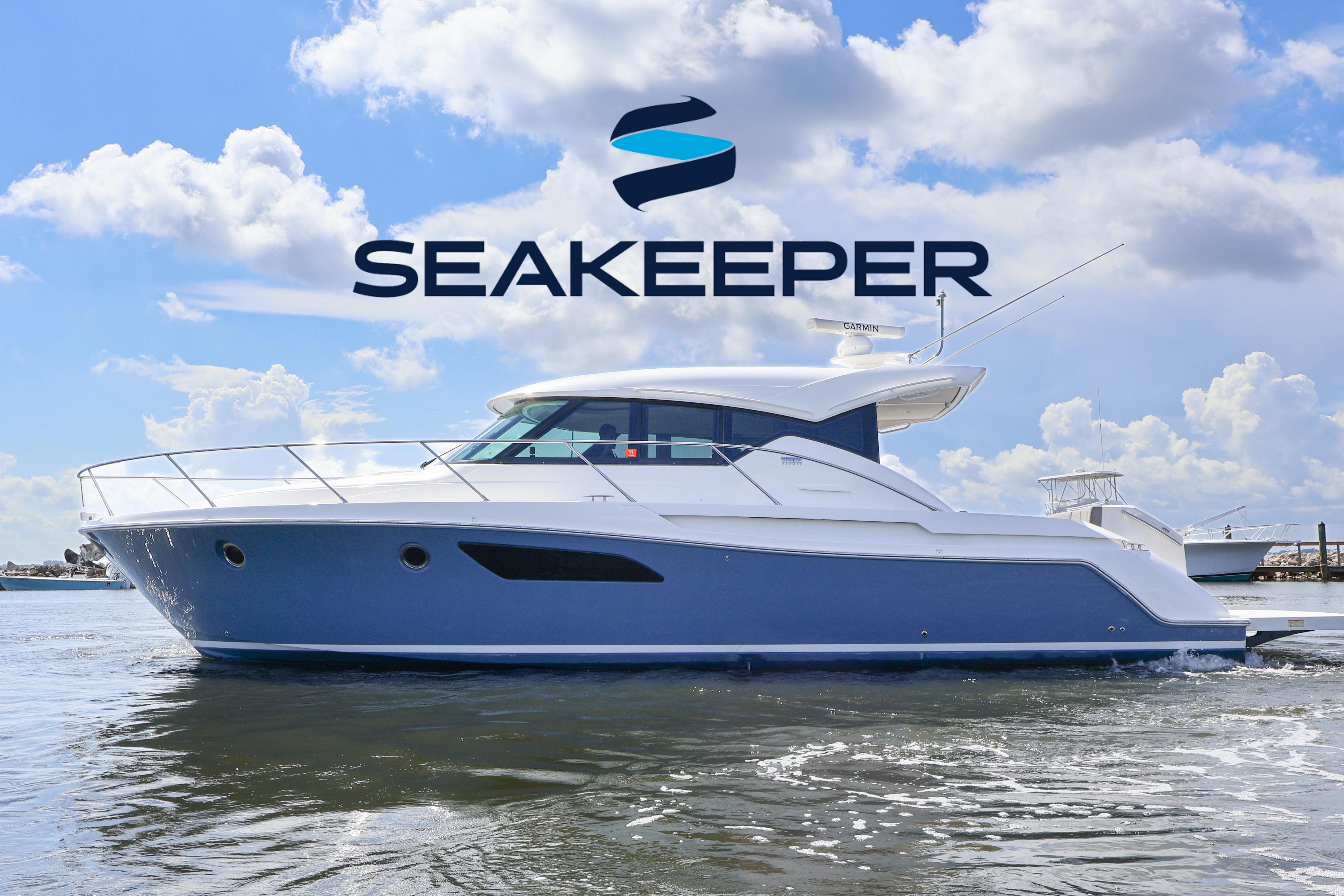 Tiara Yachts C44 Coupe 2020 Tiara Yachts C44 Coupe on water under Seakeeper logo, clear sky background.